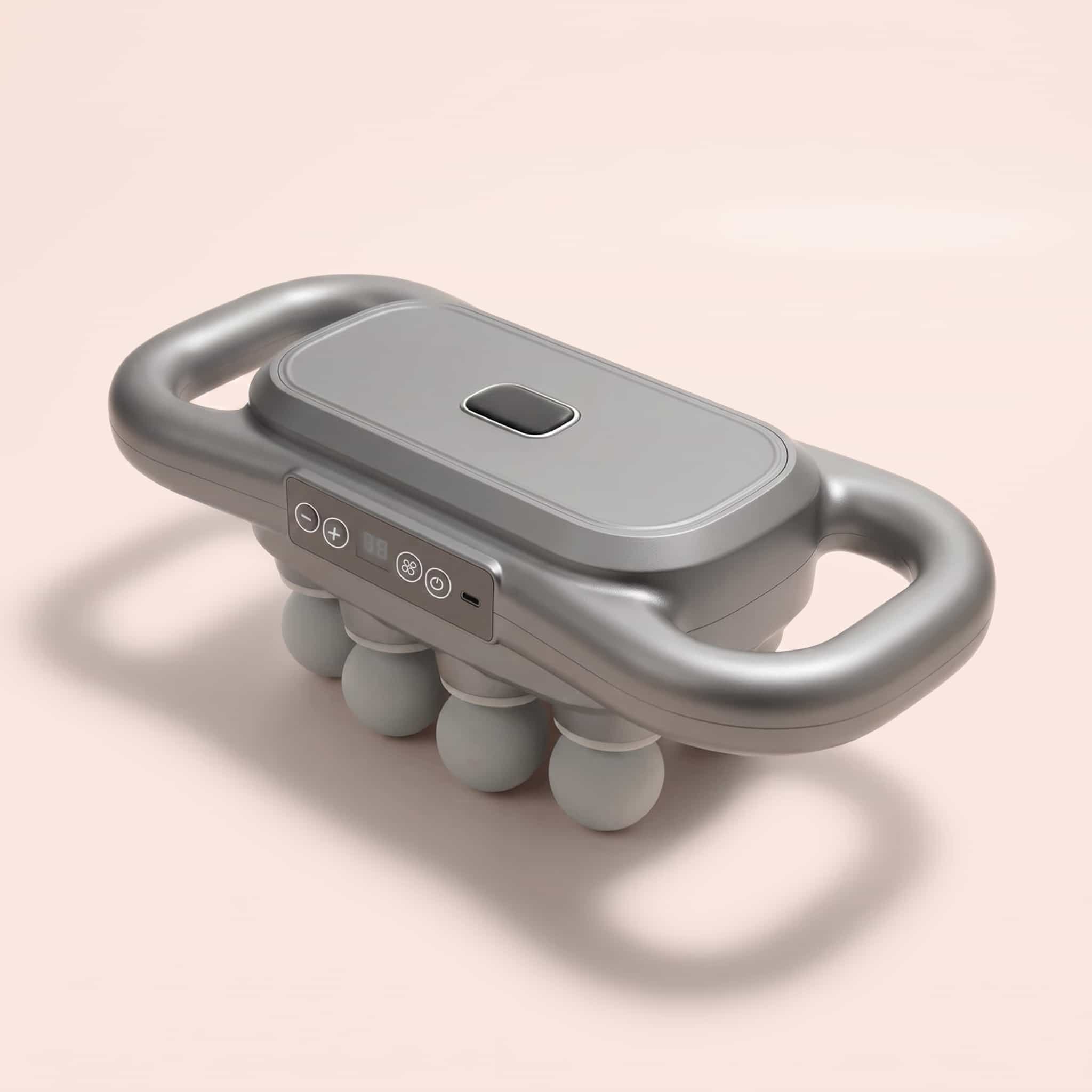 A silver electric massager with dual handles and four silicone massage nodes, shown on a light pink background.